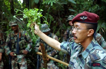 <p>Top: U.S. Marine Corps personnel from CARAT with Commander Ivan Lee of Malaysian Armed Forces, 2002<br />
Sungai Lembing, Malaysia</p>

