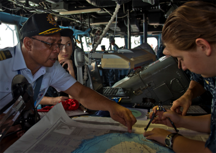 <p>Captain Elmer Magallanes (left) assists USS <em>Tortuga</em>, 2013<br />
Manila Bay, Philippines<br />
Photograph by Mass Communication Specialist 3rd Class Amanda S. Kitchner</p>
<p>Captain Elmer Magallanes, a Manila harbor pilot, works with crew members of the USS <em>Tortuga </em>to plot a safe passage through Manila Bay. <em>Tortuga </em>is part of the U.S. 7th Fleet that participated in Balikatan 2013, an annual U.S.-Philippines military training and community engagement exercise.</p>
<p>U.S. Navy</p>
