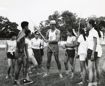 <p>Mal Whitfield teaches javelin techniques to Laotian physical education instructors, 1963<br />
Vientiane, Laos</p>
<p>Recognizing the power of sports diplomacy, the United States Information Agency, which later became part of the U.S. Department of State, began sending American athletes abroad in 1955. As one of the first global sports ambassadors, “Marvelous” Mal Whitfield, a five-time Olympic medalist, worked for 47 years as a coach, goodwill ambassador, and athletic mentor, traveling to 132 countries.</p>
<p>Bureau of Educational and Historical Affairs Papers (MC 468), box 347, folder 31. University of Arkansas, Fayetteville, Special Collections</p>
