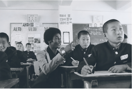 <p>Top: Peace Corps Volunteer Michael Williams teaches an English class, c. 1977-1979<br />
Euihung, Republic of Korea</p>
