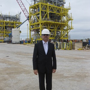 Mr. Dara Saeed standing in front of a portable refinery at Solar Technologies