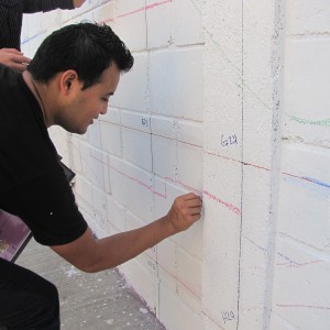 Once the grid was applied, volunteers helped sketch the design onto the wall