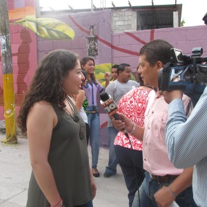 Michelle speaking with local press about the mural exchange