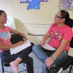 One of Michelle’s assistants, Wendy, speaks with a member of the community