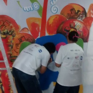 The group working quickly to finish the mural