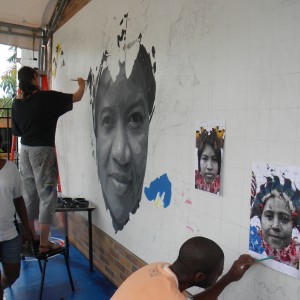 Augustina begins painting the detailed black-and-white portraits while local artists sketch details