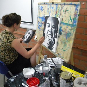 Augustina works on a portrait during the adult workshop