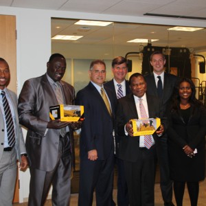 The Caterpillar team, Amb. Adefuye, and Nigerian Embassy representatives exchange gifts following the program