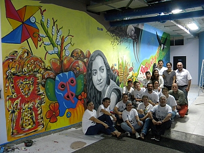 The group of artists with the completed mural at the end of the day