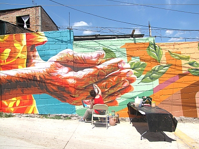 Artist Michelle Ortiz working on some of the mural details