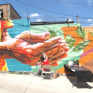 Artist Michelle Ortiz working on some of the mural details
