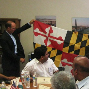 Maryland State Legislator, Ms. Arunya Miller presents delegates with the Maryland flag during luncheon at Ellicott Dredges, LLC Left to right: Mr. Ramani Ramaswamy, Mr. Jeffrey Ross Williams (Director, international activities, ContainerTrac), Mr. Sandeep Wadhwa, Ms. Arunya Miller (State Delegate, The Maryland House of Delegates), Ms. Mehnaz Ansari and Mr. G.V.L. Satya Kumar