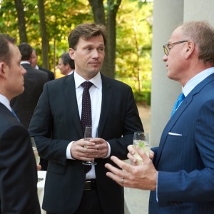 Ambassador Lose (center) speaks with Morten Skroejer from the Danish Embassy (left) and Tom Spulak from King and Spalding (right)