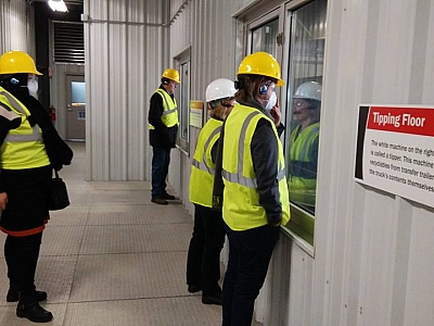 Visitors taking a hard hat tour of the Rumpke Recycling Company in Cincinnati, OH