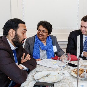 Vijaya Ramachandran, Senior Fellow at the Center for Global Development, and Travis Foxhall, Investment Associate at Quona Capital, smile as Usman Ahmed, Head of Global Public Policy at Paypal, reacts to a conversation on future finance policies and blockchain technology.