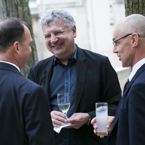 Leaders of Bill & Melinda Gates Foundation’s Financial Services for the Poor program – from left, Michael Wiegand, Kosta Peric and Jason Lamb – raise a glass at the reception in Meridian’s Linden Grove.  Photo by Kristoffer Tripplaar.