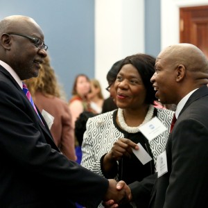 Ambassador of Namibia Martin Andjaba shakes the hand of Welcome Simelane, a Minister-Counsellor (Political) with the Embassy of South Africa, as former South African Public Prosecutor Thuli Madonsela looks on.