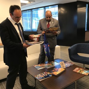 Participants from Saudi Arabia and the Palestinian Territories taking a look at a couple of USA Travel Brochures after meeting with Brand USA