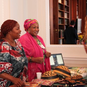Ms. Ellen Zeze KEITTA, CEO and Manager of Ellen Zeze’s Art Shop from Liberia, and Ms. Zainab MUSTAPHA JAJI, CEO of ZMJ Integrated Services from Nigeria, showcase their products with an attendee.