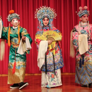 Actors in traditional garments and makeup perform Beijing Opera