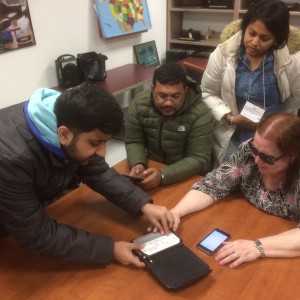 Disability Rights advocates from South Asia examine a mini-braille note-taker with Kim Charlson, President-elect of the North American and Caribbean Region of the World Blind Union, at the Perkins School for the Blind in Watertown, Massachusetts.