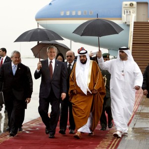 US President Bush holds an umbrella as he is escorted by President of  the UAE Sheikh Khalifa in Abu Dhabi