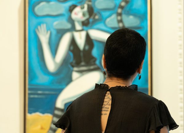 A woman views a painting at the Unlimited: Egyptian Contemporary Art Exhibition at Meridian.