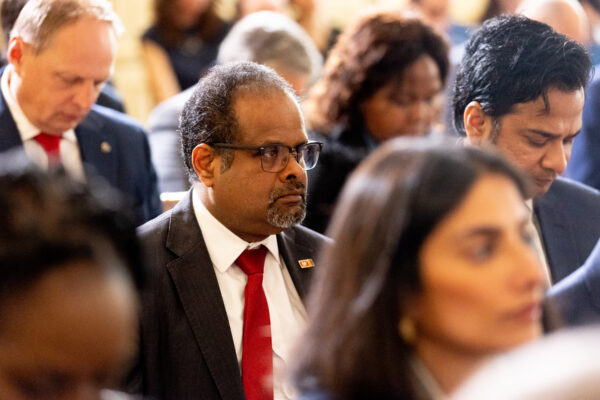 Ambasador of Sri Lanka listens while seated